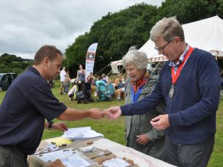 A photo of the Ranger showing visitors some ancient artefacts discovered at Dawlish Countryside Park