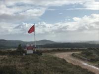 Red warning flag flying on Pebblebed Heaths